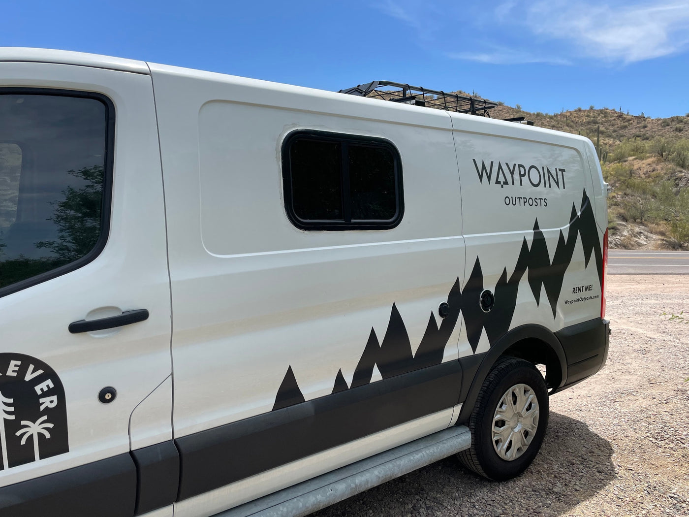 Waypoint Outposts white camper van, featuring mountain graphics, is ready for RV rental adventures. — photo 5