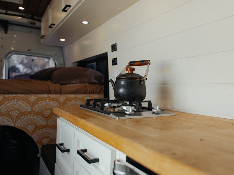  and mini-fridge for travel.|A top-down view of an RV rental interior: a compact kitchen area with a stainless Frigidaire mini-fridge — photo 6