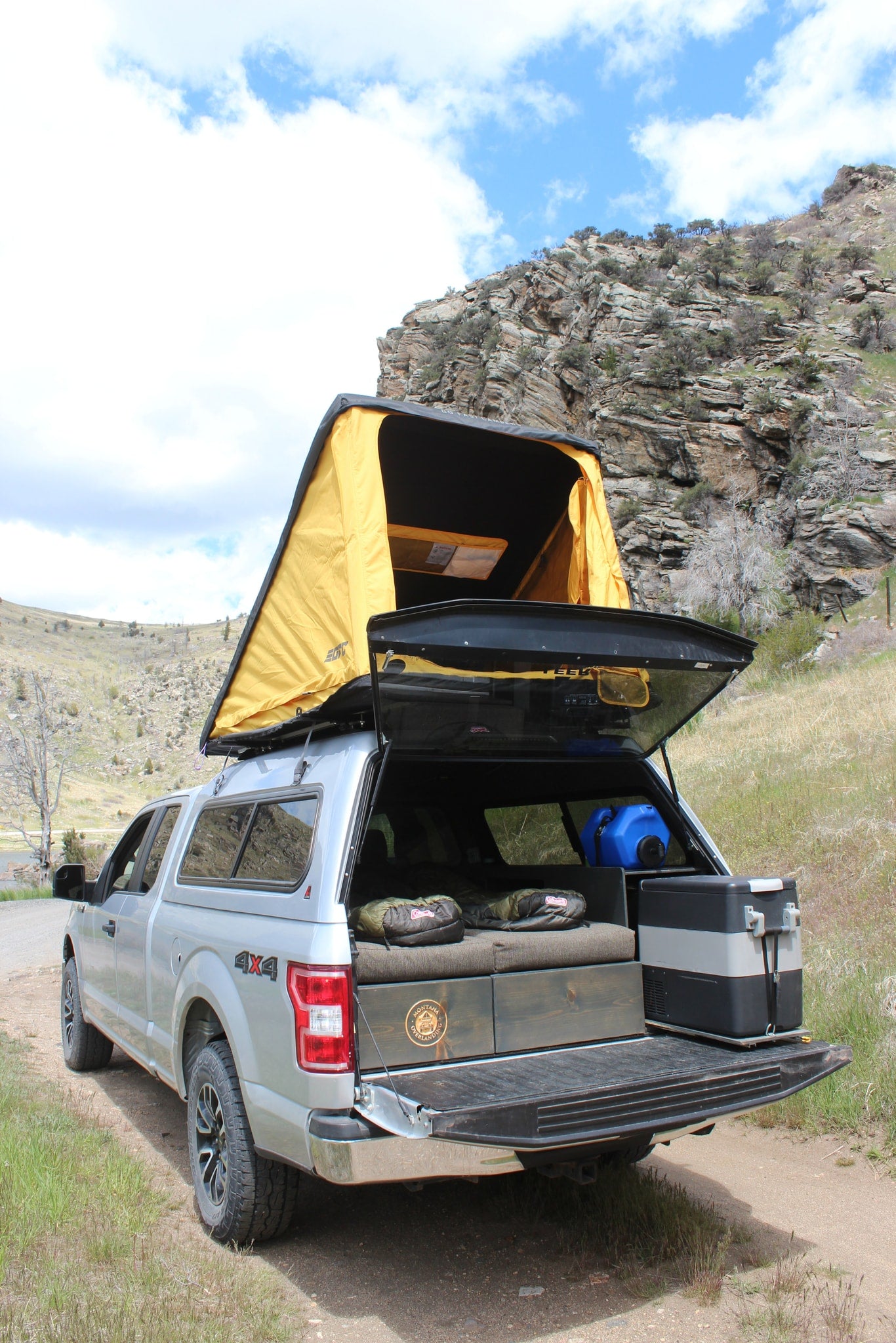 This F-150 truck camper with a rooftop tent, bed setup, and fridge is a versatile RV rental option for wilderness adventures. — photo 6