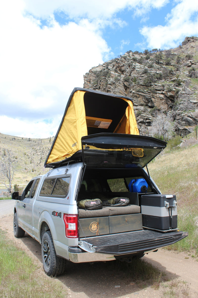 This F-150 truck camper with a rooftop tent, bed setup, and fridge is a versatile RV rental option for wilderness adventures. — photo 6