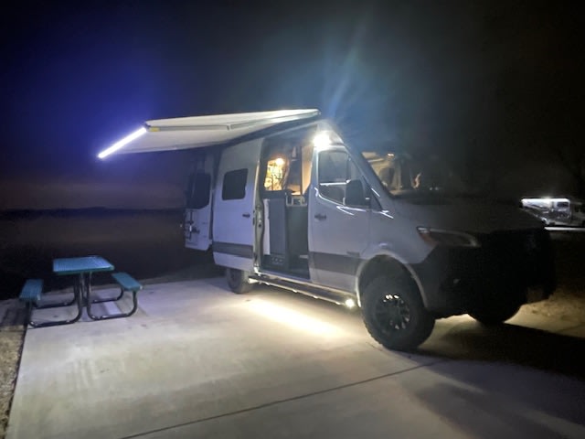  a green picnic table in front. Perfect travel & camping scene.|Light gray Mercedes Sprinter RV rental parked at Munship Park — photo 5