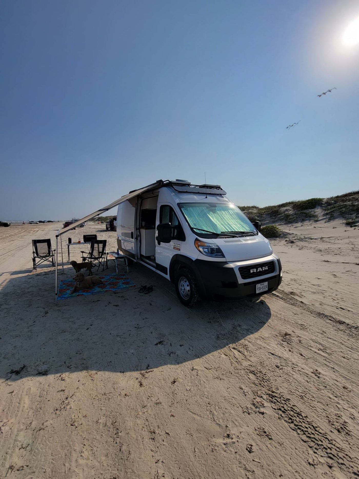  perfect for winter adventures in the mountains.|RV rental van at a scenic mountain campsite. A person stands by a white camper van — photo 6