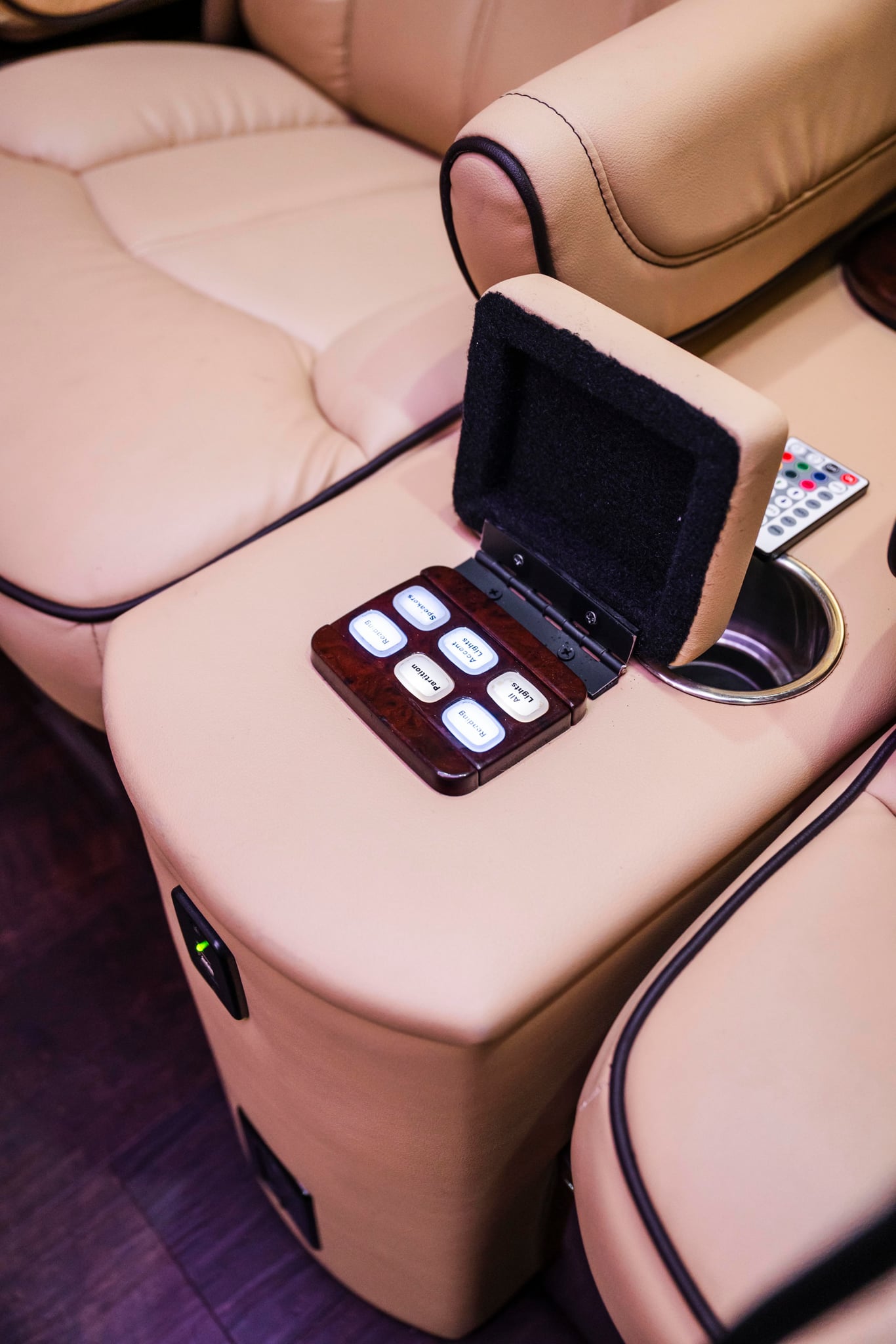  and integrated controls.|Luxury rv rental interior with plush captain's chairs — photo 7