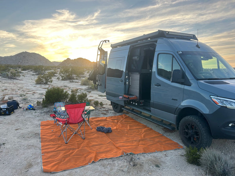Picture your next adventure: an RV rental camper van set up for comfortable desert camping at sunset.|This Jayco Terrain 4x4 RV rental — photo 1