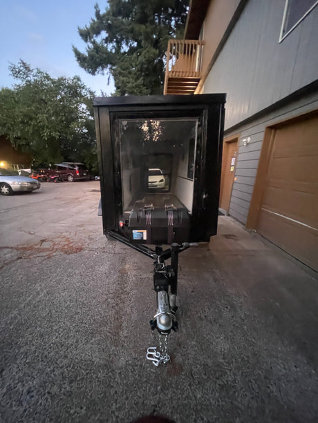 Enclosed trailer with a car inside. A practical addition to consider for your next rv rental.