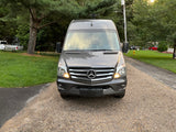 Front view of a modern gray Mercedes-Benz Sprinter van, equipped for travel. Explore the open road with this RV rental.