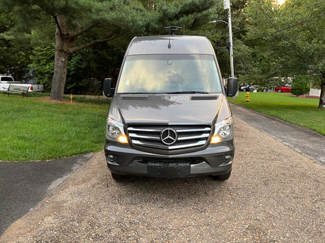 Front view of a modern gray Mercedes-Benz Sprinter van, equipped for travel. Explore the open road with this RV rental.