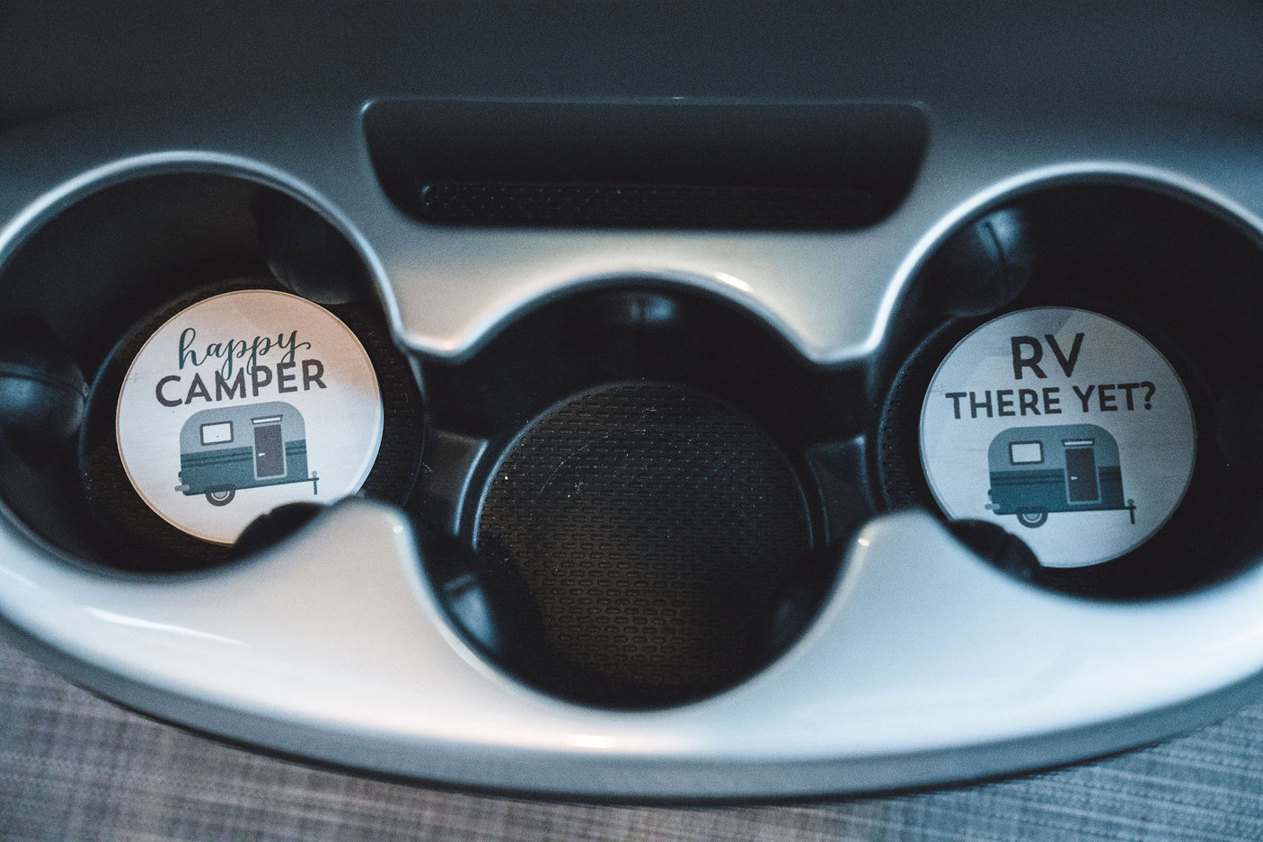 RV-themed car coasters: 'happy CAMPER' and 'RV THERE YET?' with travel trailers. Great for an RV rental adventure!