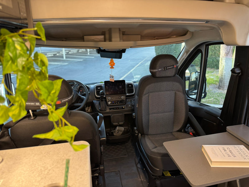  and an open door revealing a scenic sunset view.|Relax in this cozy RV rental bedroom. Olive green bedding — photo 4
