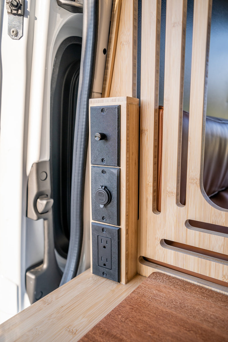 Interior view of an RV rental showing modern bamboo paneling with integrated power outlets (USB, AC) and a control knob. — photo 20