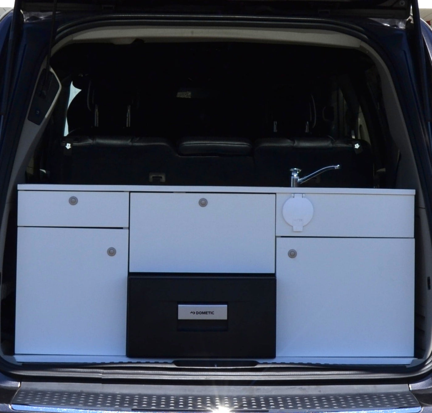  and a buffalo check comforter. Windows reveal green trees.|Cozy vehicle interior — photo 7