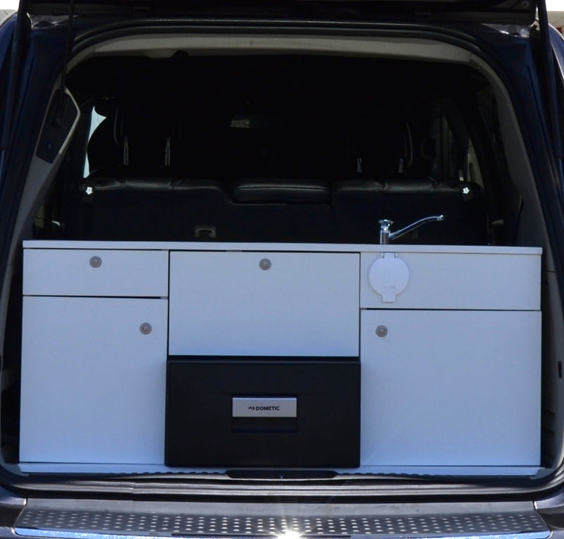  and a buffalo check comforter. Windows reveal green trees.|Cozy vehicle interior — photo 7