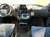 Inside an RV rental: a Dodge steering wheel, dashboard with Kenwood stereo, gear shifter, and front passenger & driver seats.