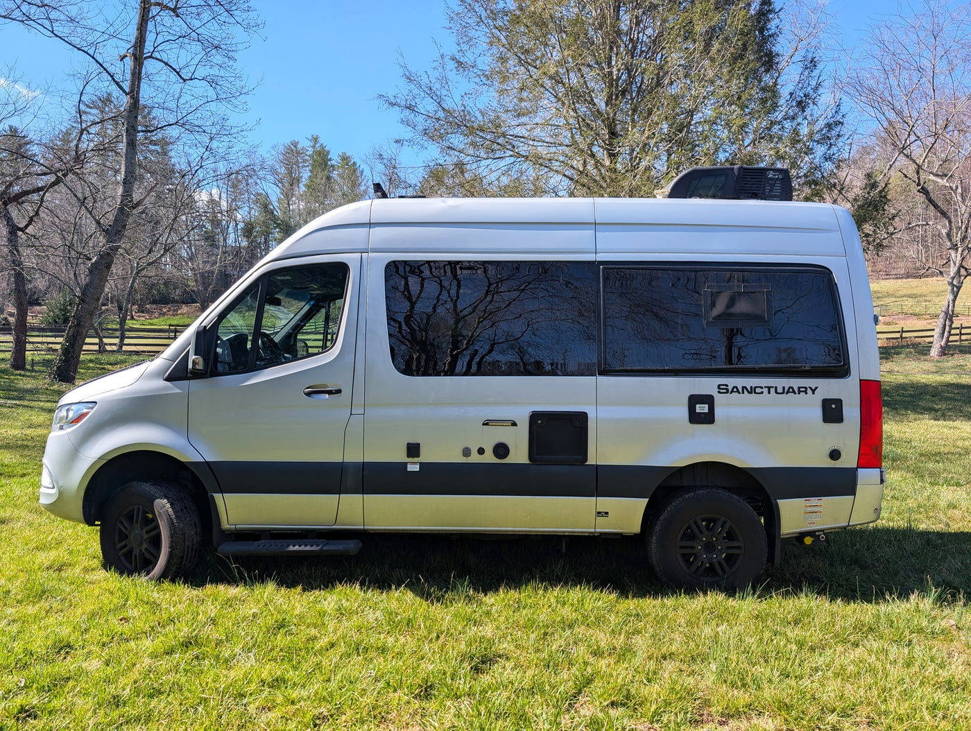  and a compact kitchen.|Rear of a silver Thor Sanctuary Sprinter RV rental with a bike rack — photo 15