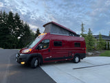 Vibrant red Winnebago Solis pop-top camper van, ideal for your next rv rental trip.