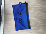 A blue "CORDS" tech gear pouch, ideal for organizing cables and items in your RV rental.