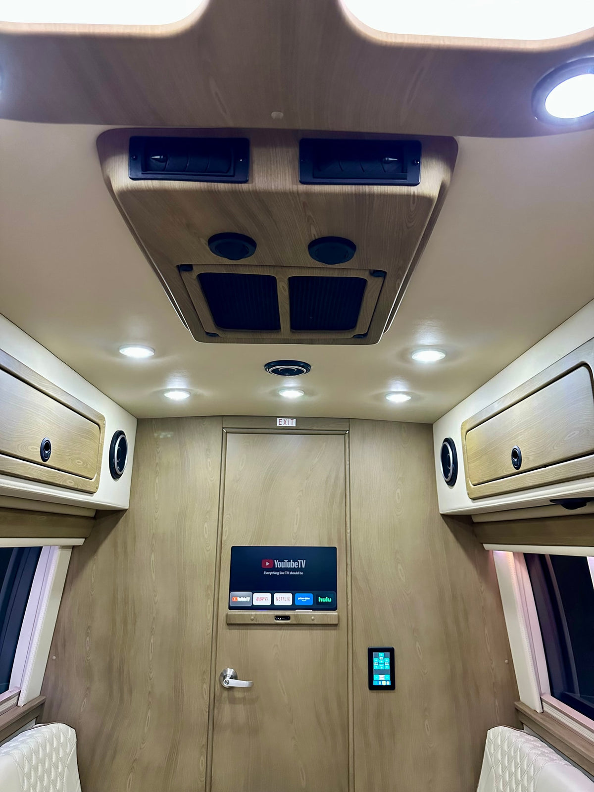  and wood flooring.|Inside a premium rv rental: cream quilted captain's chairs — photo 16