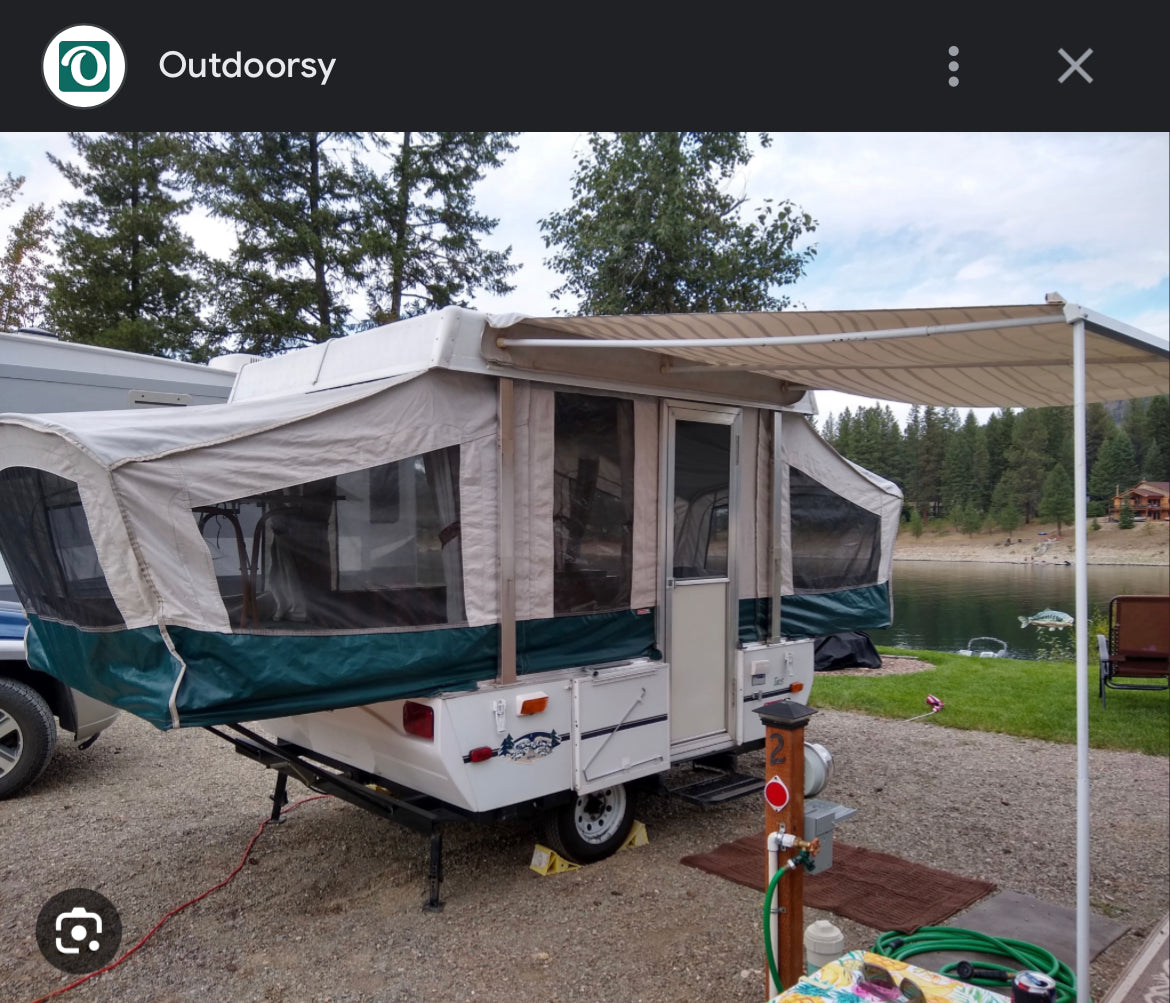 This pop-up camper RV rental offers a perfect lakeside retreat, complete with an awning for shade.