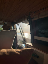 Experience serene beach mornings from this cozy RV rental! Enjoy ocean views and golden light from inside your van.