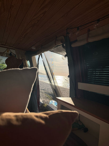 Experience serene beach mornings from this cozy RV rental! Enjoy ocean views and golden light from inside your van.