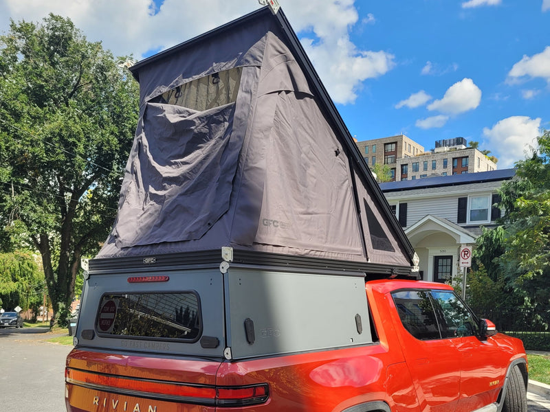  ideal for an rv rental adventure.|Red Rivian R1T electric truck w/ open camper shell & tailgate. Explore off-grid with this rv rental ready setup!|Red Rivian R1T electric truck with an open bed setup — photo 19