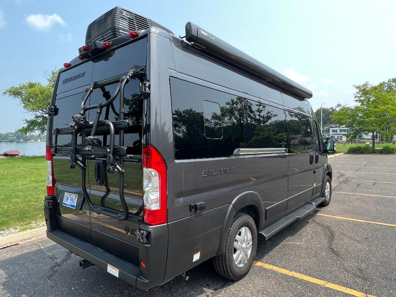  often used for rv rental adventures.|Rear view of a dark grey RV rental camper van. It features a bike rack — photo 3
