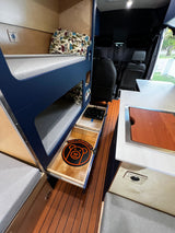 Inside a compact rv rental, a bunk bed setup, pull-out induction burner, and storage drawers maximize space.