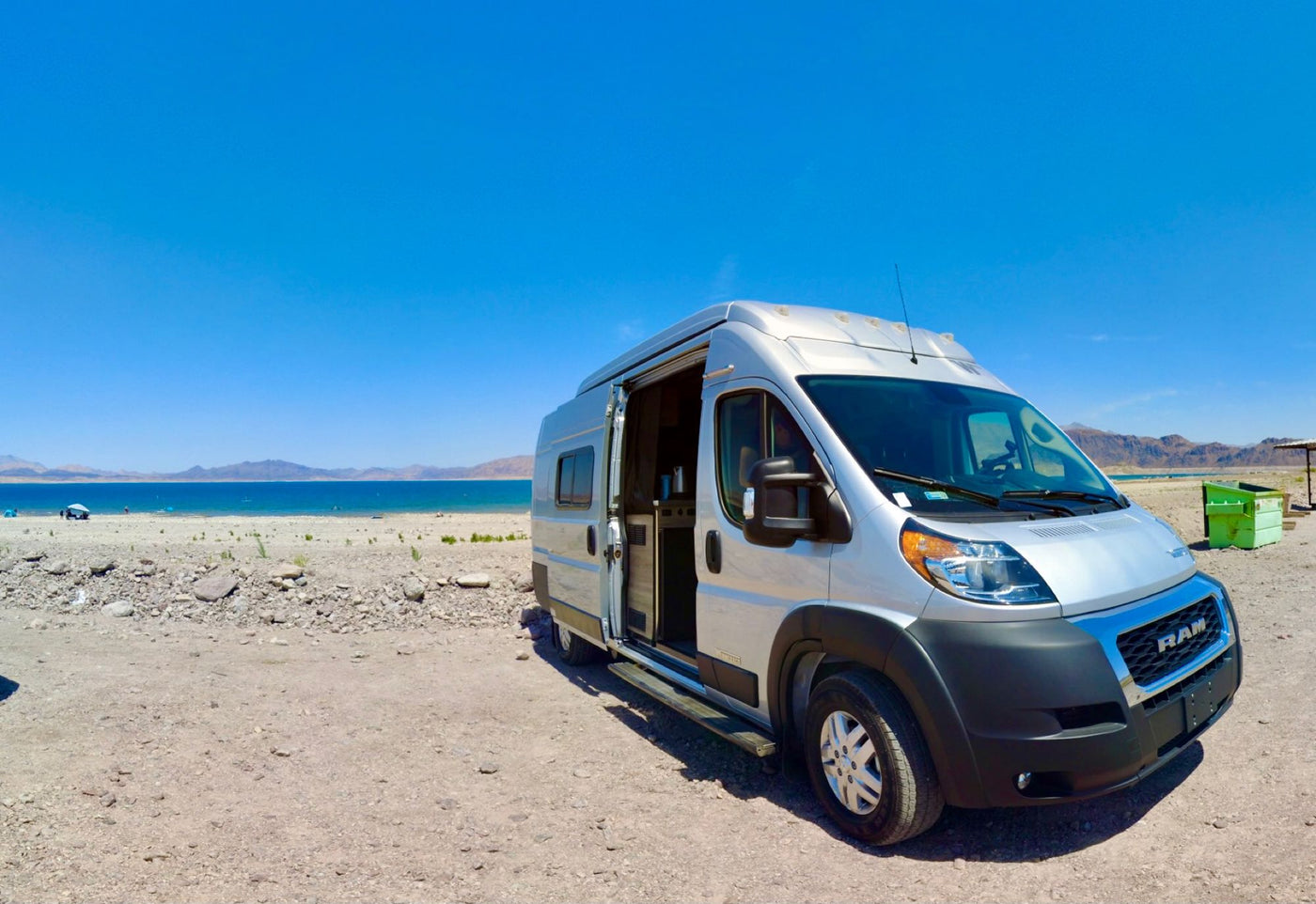  and practical amenities for travel.|RV rental camper van with pop-top at a scenic desert campsite — photo 7