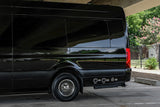Black luxury RV rental from Ultimate Toys, seen from the rear side. Features fresh and city water connections for convenient use.