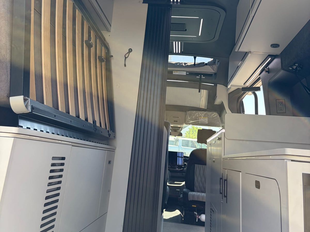  and front seats featuring custom logos and 'AIRBAG' labels.|Modern RV rental interior: 'LINEAGE' kitchen with fridge — photo 6