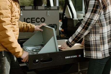 This RV rental features a pull-out Nomad Kitchen & ICECO fridge/freezer, perfect for outdoor cooking and camping adventures.