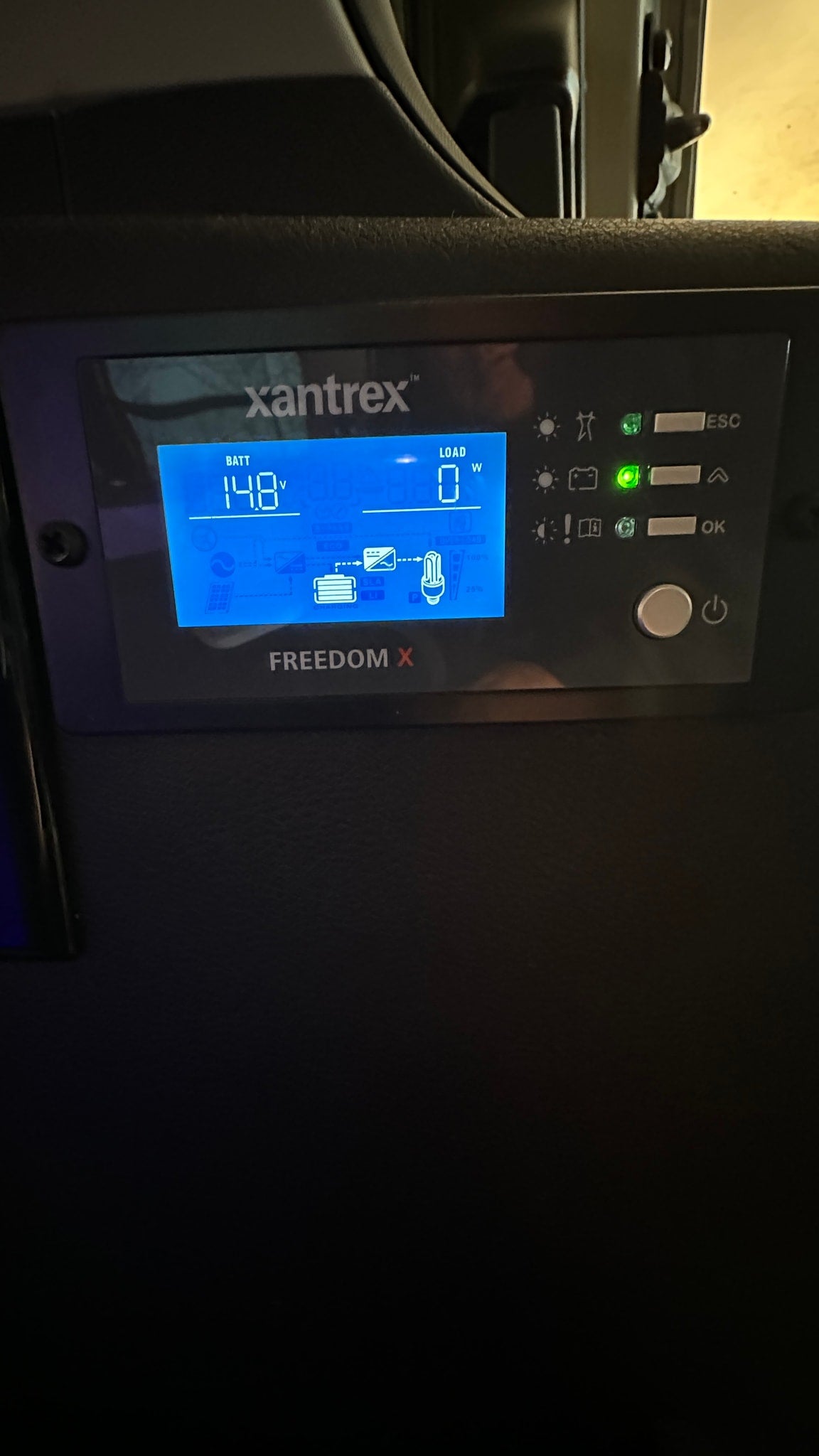 This Xantrex Freedom X inverter display in an RV rental shows 14.8V battery and 0W load, monitoring the electrical system in a camper. — photo 10