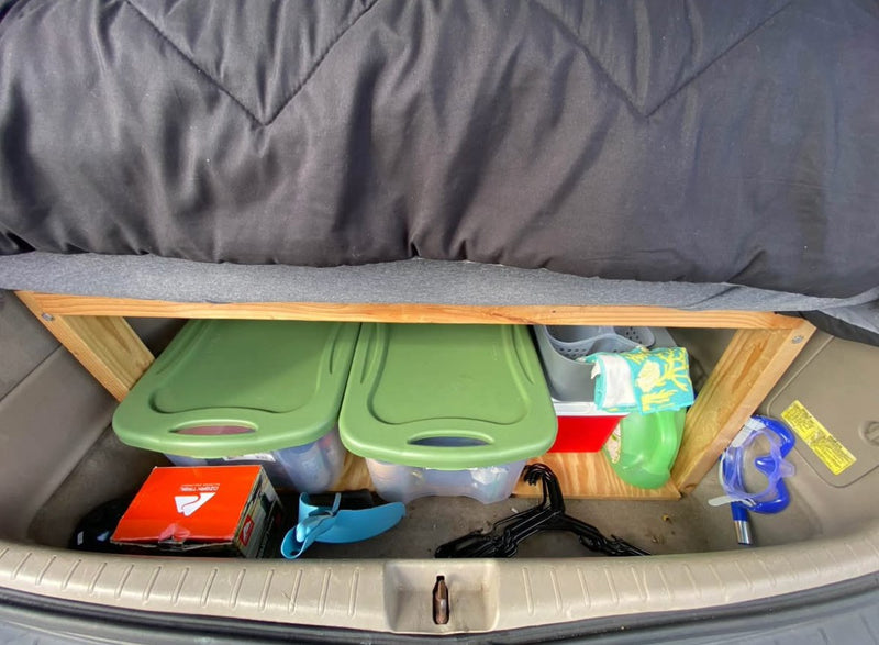  and colorful string lights for a comfortable road trip.|Maximize space in your RV rental! A custom platform creates under-bed storage for bins — photo 3
