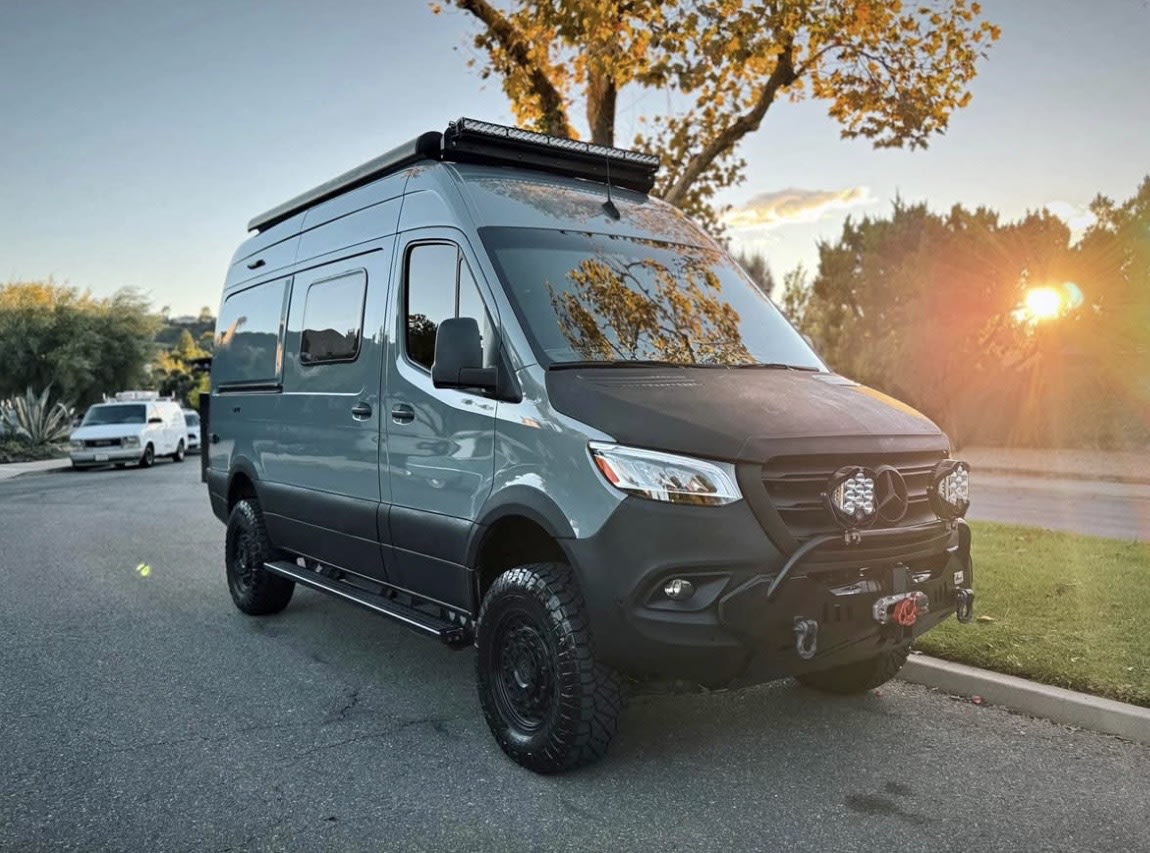 Custom gray Mercedes Sprinter adventure van, ready for your next rv rental. Features off-road tires, winch, and roof lights. — photo 5