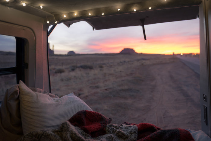  ready for your camping provisions. Essential for comfort on the road.|Compact RV rental interior: Rear view showing a folded bed