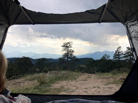 RV rental: Wake up to stunning mountain views & pine trees from your tent. Scenic outdoor camping experience.