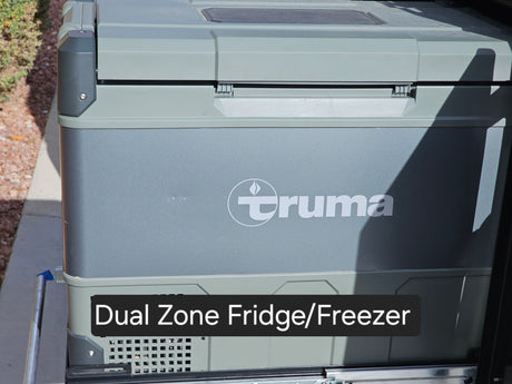 A grey Truma Dual Zone Fridge/Freezer on a slide-out tray, ready for your RV rental adventure.