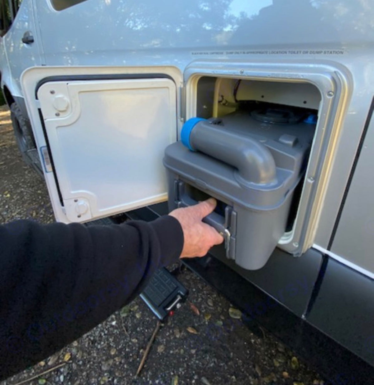  revealing the gray toilet waste cassette. Essential for sanitation & easy disposal during travel.|Driving an RV rental: View from driver's seat. Hands on Mercedes wheel — photo 12