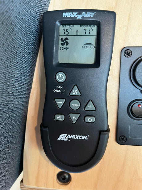 Maxxair vent fan remote in an RV rental, showing 71°F room temp, 75°F set temp, and fan off.