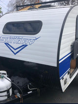 Front side of a white SunRay Classic travel trailer with blue accents, ideal for rv rental. Propane tank in view.