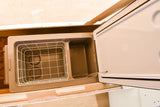 Portable RV rental cooler with lid open, showing wire basket & storage compartment.