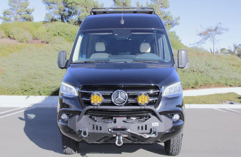 This black Mercedes Sprinter camper van, equipped with custom off-road bumper, winch, and lights, is an ideal rv rental. — photo 4