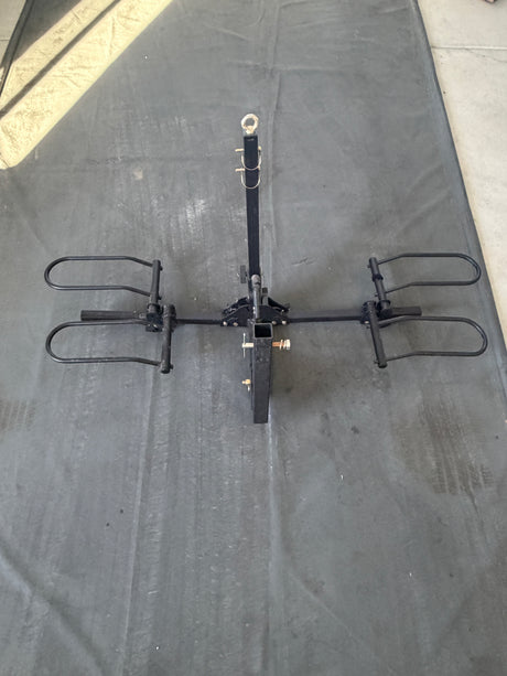 Visually, a black 2-bike hitch mount rack, perfect for an RV rental to transport bicycles on outdoor adventures.