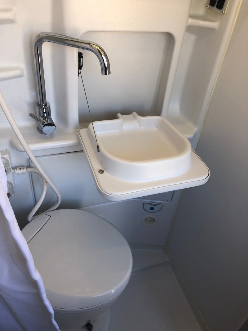  & open kitchen area for camping.|View inside an RV rental: This camper van features a kitchen with stove/sink — photo 15