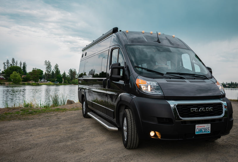  and two chairs.|Compact RV rental kitchen: speckled counter with induction cooktop — photo 9