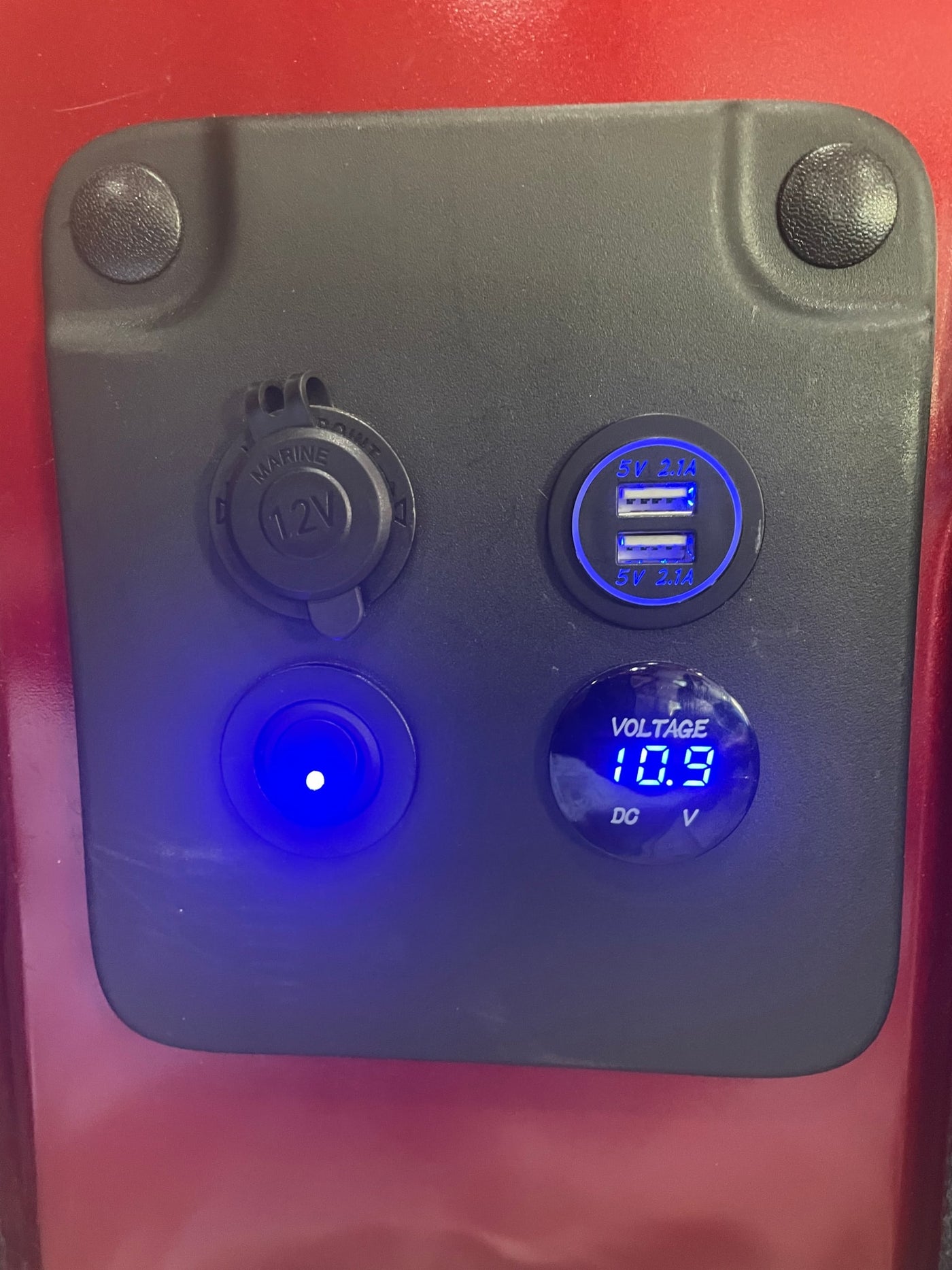 RV rental power panel: glowing blue 12V outlet, dual 5V 2.1A USB, lit button, & 10.9V DC voltmeter. — photo 9