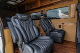 Plush RV rental interior features black diamond-stitched captain's chairs with "Legends" headrests, wood cabinets, and flooring.