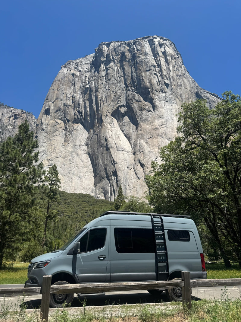  and under-bed gear.|Inside a custom rv rental van conversion: comfortable living area with opposing cushioned benches — photo 2