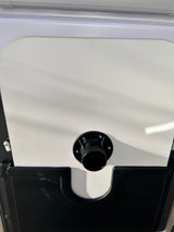 Black electrical power inlet on white RV rental side, ready for hookup. Essential for recreational vehicle power.
