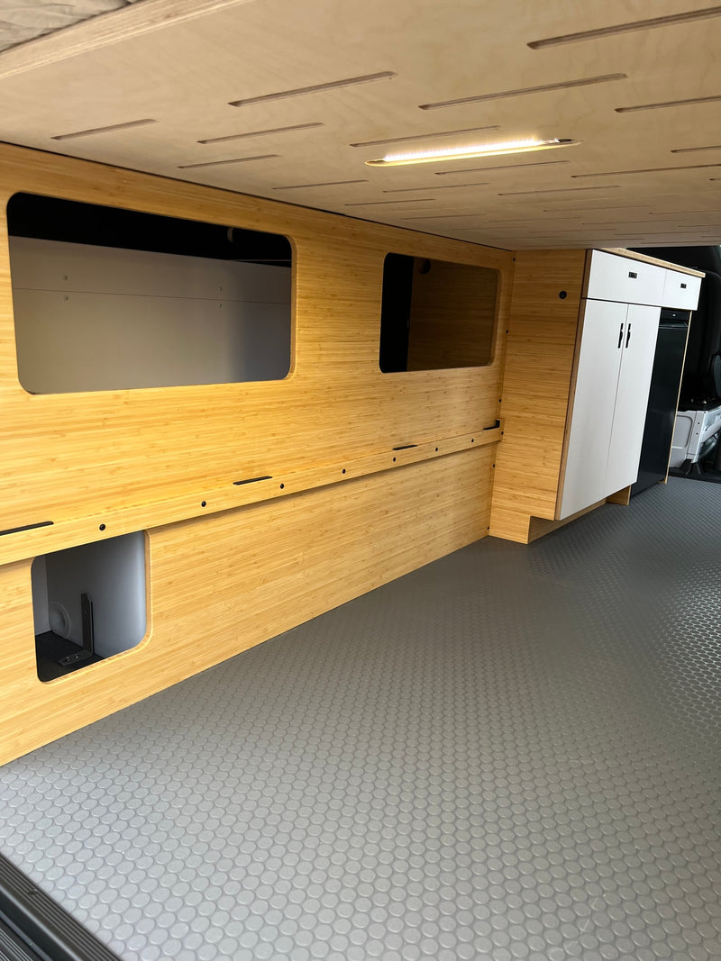 Custom RV rental camper van interior. Shows bamboo walls with storage, integrated lighting, white cabinets, and durable flooring. — photo 17